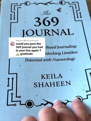 A close-up of a book titled "The 369 JOURNAL" with light blue cover. Below, the name "KEILA SHAHEEN" is visible. A comment box asking a question about posting the journal again. A hand is partially in the foreground, touching the book.