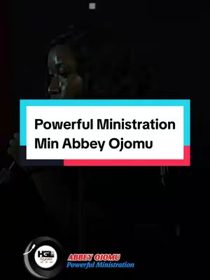 The cover image presents a dark, stage-like setting. A woman with visible makeup wearing dark clothing, is positioned on the left side of the frame. The focal point is a rectangular text overlay with rounded corners, featuring the title "Powerful Ministration" in bold white font, subtitled "Min Abbey Ojomu". Below, a circular logo frames further text against a black backdrop with a red stripe at the bottom, which adds visual contrast.