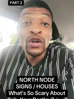 A close-up shot of a man in a car wearing a striped shirt, with text overlays. The man has a dark complexion, short dark hair, and is looking directly at the camera with an open mouth as if he is speaking. The background is blurred, suggesting he is inside a vehicle.