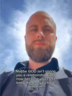 The cover image shows a man from the chest up, set against a sunny, cloud-filled sky. The man has a shaved head, a beard, and is looking directly at the camera. Text overlayed on the image in a simple white font reads, 'Maybe GOD isn't giving you a relationship right now because you can't keep the one you have with him..'