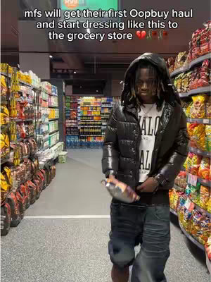 A person stands in a grocery store aisle, dressed in a black puffer jacket and jeans. Text overlays at the top. Shelves of products line both sides of the aisle.
