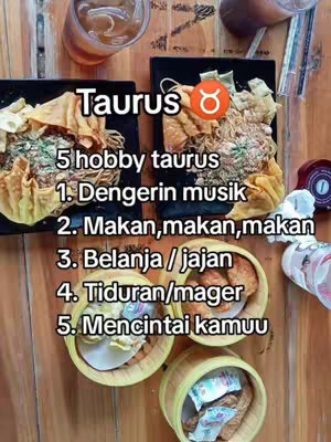 An overhead shot of a wooden table with several food dishes and drinks. There are four small, round wooden bowls filled with what appears to be fried food positioned in the foreground, with a variety of other dishes in the background. Text overlaid on the image describes the hobbies of a Taurus.