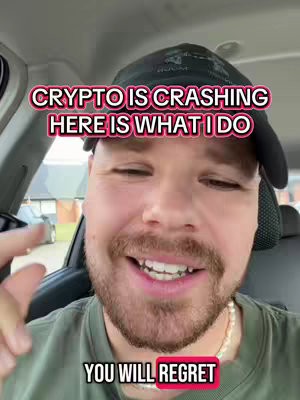 A selfie-style video cover image features a man in a car, with text overlays in a bold, sans-serif font. The man has a beard, wearing a baseball cap, and appears to be in the driver's seat, with a faint street scene visible through the window behind him. The text conveys a financial or crypto-related message.
