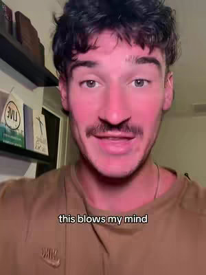 A man with short dark hair and a mustache looks directly at the camera and speaks. The focus is a close-up of his face, which has a reddish complexion. Below is text overlayed on the image that reads: "this blows my mind."