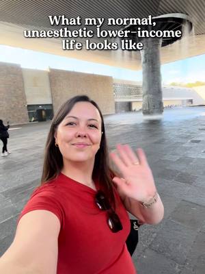 A woman in a red top waves at the camera, with an urban environment in the background. Text overlaid identifies the subject.