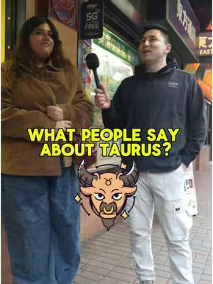 A vertical video cover image showing two people standing outdoors. On the left, a person with long dark hair and is wearing a brown coat. On the right, there is a person holding a microphone in front of them. Added as an overlay on the bottom is a Taurus astrological symbol with the text overlay: WHAT PEOPLE SAY ABOUT TAURUS?