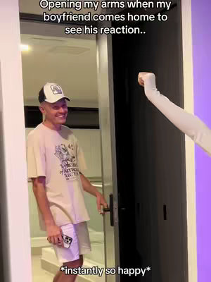 A man in a white shirt and shorts stands in a doorway as a hand reaches towards the door, text overlays the image.