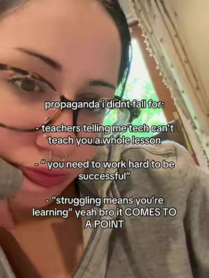 A close-up shot focusing on a woman's face, wearing glasses. Text overlays are present, with a natural background of a curtain and a window visible.