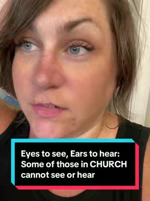 A close-up shot focuses on a woman's face. She has light skin, blue eyes, and brown hair parted on the side. She's wearing a black top, and a colorful rectangular block with text overlaid. The lighting appears to be soft, and the overall composition emphasizes her expression.