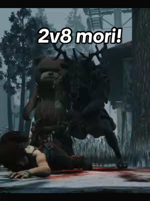 The image is a scene from a video game. In the center is a monster-like character, clad in dark clothing with antlers. To the left of the monster is a person in a teddy bear costume. In the foreground, a person lies on the ground, with a pool of blood in front of them. Text overlay, in white font, reads '2v8 mori!'. The background is blurred, with trees visible.