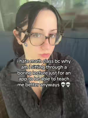 A young woman with dark hair and glasses looks directly at the camera with a somewhat displeased expression. Overlayed text explains that she hates math class because apps can teach math better than boring lectures.