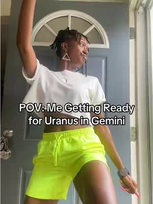 A person in front of a door with a small window. The person is raising their arm. Text on the image overlay reads, “POV: Me Getting Ready for Uranus in Gemini”.