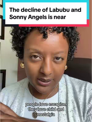 A woman with curly dark hair is centered in the frame, her gaze directing towards the viewer. She wears a white cardigan and a gold necklace. Above her, text is placed in a white and colored rectangle, with additional text at the image's bottom. The background includes hints of a room.