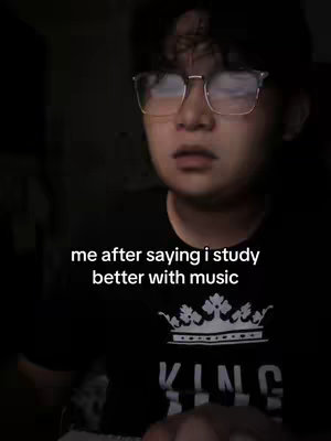 The image shows a person with glasses looking upward with a stressed expression. Overlayed text indicates it is a reaction to a statement about studying with music.