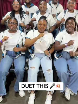 Group of diverse people smiling and posing with their fists up. Text overlay announces "DUET THIS" with microphone and sparkle emojis.