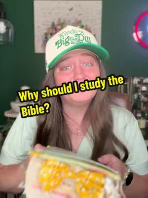 A woman with a "Kinda a Big Dill" hat holding a container in front of her, with text overlaid. The background shows an abstract painting, and a green wall.