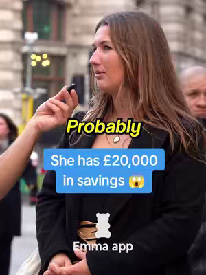 A woman interviewed on the street reacts to a mic being held up to her. The image features overlay text in blue, yellow and white.