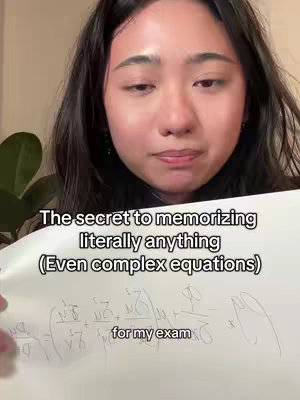 A person holding a sheet of paper with handwritten equations, with text overlayed on the image.