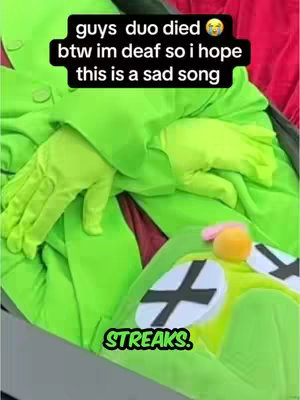 The image appears to be a meme or a humorous take on the Duolingo owl mascot. It shows a person in a green costume resembling the owl. The costume only reveals the person's hands; the rest of the owl's body and mascot face are visible. A text overlay is added at the top and across the bottom, enhancing comedic effect.