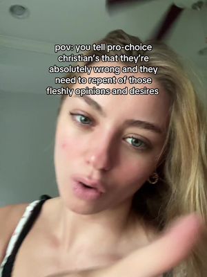 A selfie-style image features a young woman with fair skin, blonde hair, and blue eyes. She is looking directly at the camera with a slightly concerned or questioning expression. Above her, overlaid text reads: "pov: you tell pro-choice christian's that they're absolutely wrong and they need to repent of those fleshly opinions and desires". The background is blurred, suggesting an indoor setting possibly near a window.