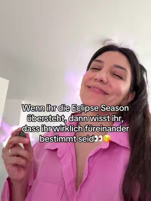 The cover image features a woman with dark hair wearing a pink shirt. Text is overlaid on the image. The background is subtly blurred, suggesting to be at home, with soft lighting. The woman is smiling and holding a small accessory.