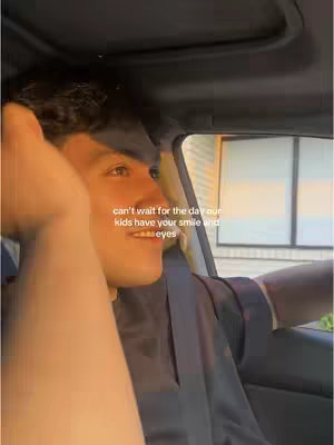 The video shows a man in a car during what appears to be sunset. The man is looking toward the left of the image, with a smile on his face. The text overlay is a quote.