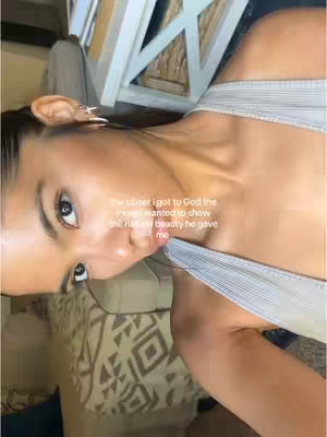 A selfie-style shot featuring a young woman. She's fair-skinned with dark hair, minimal makeup, and is angled slightly upwards. The text overlayed on the picture is white.