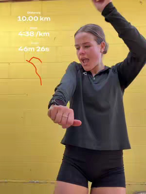 The cover image shows a young woman in athletic attire, celebrating with an open mouth and arms raised. The background is a solid yellow color, and text overlays show running metrics such as distance, pace, and time. The image is well-lit, and the woman is the clear focus, capturing a moment of triumph or excitement.