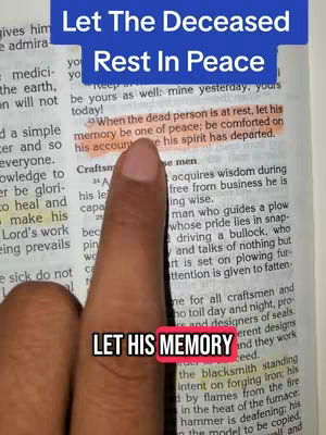 A hand points to highlighted text within an open book, with overlayed text at the top and bottom. The top text reads 'Let The Deceased Rest In Peace' in a blue banner. The bottom text has 'LET HIS MEMORY' in a red banner.