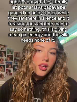 A selfie-style video shows a young woman with long, wavy hair, dark clothing, and a neutral-toned background with photos. She is speaking, with text overlaid at the top of the frame. The background provides context by a wall with pictures and decorations, creating a personal setting.