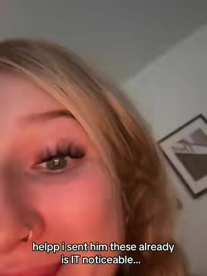 A close-up of a person's face, focusing on their eye and part of their face, with text overlayed at the bottom. The person has blonde hair and a nose ring. The background is dimly lit, possibly indoors.