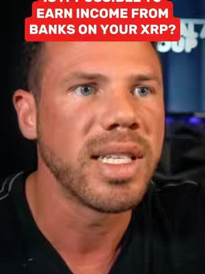 A close-up of a man's face, with a red bar at the top containing overlaid white text. The man has short hair, is unshaven with a beard, and appears to be talking.