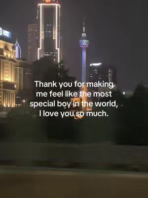 The cover image shows a night cityscape featuring illuminated skyscrapers and a tall, brightly lit tower. In front of the skyline, there is a dark, blurred foreground. Overlayed on the image is a white text at the bottom, expressing gratitude and love.