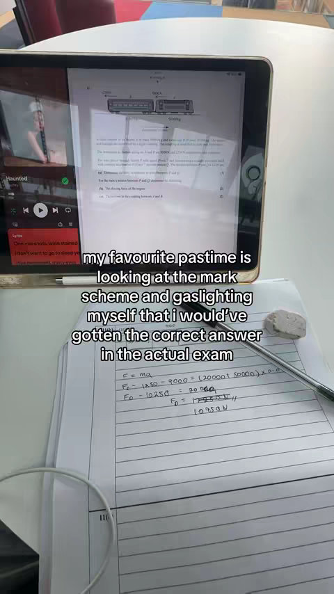 An iPad is propped up, displaying a math problem and related information, with other papers and a pen nearby, suggesting a study setting. The text overlay adds context and emotion.