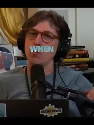 The cover image shows a person with glasses and a headset on, positioned in front of a microphone, and text overlayed saying 'WHEN'. The background features a stack of books and other objects on a table.