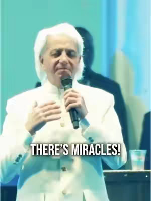 The cover image features a man in a white suit speaking into a microphone on a stage. The background has a blurred figure and a light blue color palette. The overlay text 'THERE'S MIRACLES!' is displayed prominently.