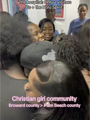 A group of women are crowded together, with several looking towards the camera with concerned or supportive expressions. Text overlays describe the scene as a hospital visit, specifying that there were only two visitors besides the Holy Spirit. Additional text mentions a Christian girl community, with a reference to two counties.