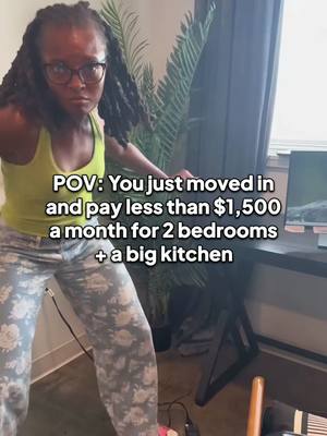 A woman in a vest and printed pants leans towards the camera, seemingly addressing the viewer. White text overlays the image.