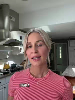 The cover image shows a woman in a kitchen, likely recording a video. She is positioned in the center, wearing a red and white striped shirt. In the background, a stainless steel range hood is visible, along with white cabinets and a glimpse of a garden. The lighting appears natural and the composition frames the woman from the chest up, emphasizing her face and expression.