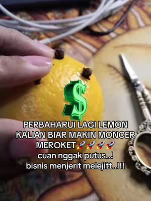 A hand holds a yellow lemon with cloves stuck into it. A green dollar sign graphic is over the lemon. Text overlays appear below.