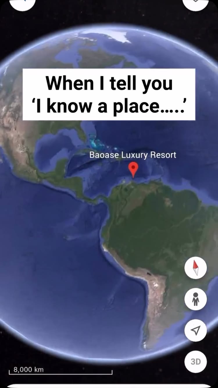 The cover image is a stylized depiction of the Earth from a satellite perspective. A white text box overlays the image, containing the phrase "When I tell you 'I know a place.....'". A red location pin labeled "Baoase Luxury Resort" is placed over the Caribbean Sea, with the resort's name. Additional interface elements such as a compass, person outline, and a paper airplane-like icon appear on the right. The overall composition uses a palette of blues, greens, and white.