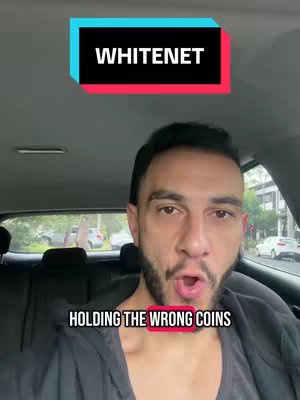 A selfie-style shot taken from inside a car. The person is looking directly at the camera with an open mouth. Text appears on a bar at the top reading "WHITENET" and another below that reads "HOLDING THE WRONG COINS". The general vibe suggests a financial crypto theme.