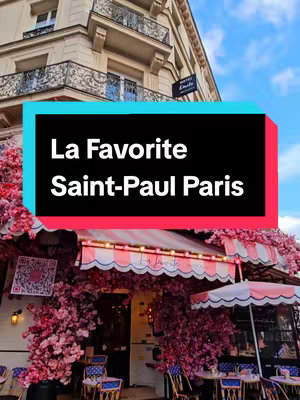 The cover image shows the exterior of a Parisian cafe, 'La Favorite Saint-Paul,' adorned with pink floral decorations. The cafe has a white and pink striped awning, and tables and chairs are set up outside. The text overlay indicates the cafe's name and location.