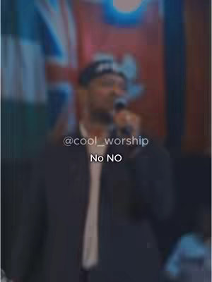 A blurred image featuring a man with a microphone, likely singing or speaking. The foreground is dominated by a dark jacket and a white shirt. Text overlays include the username '@cool_worship' and the words 'No NO'.