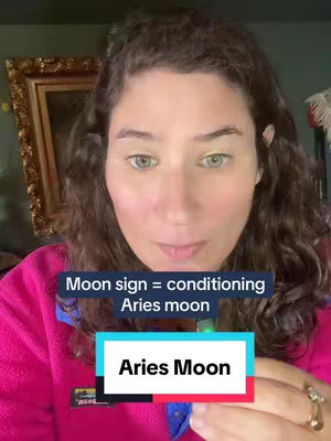 A woman with curly brown hair and green eyes looks directly at the viewer. She wears a pink fleece and is in a room with a decorated gold frame and a pink lamp. Text overlays include a quote at the top and a call-to-action rectangle at the bottom.