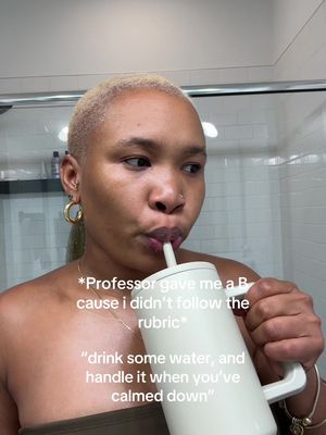 The cover photo is a selfie of a person with short, light-colored hair, wearing hoop earrings and a dark top, drinking from a white tumbler with a straw. Text overlays appear on the image, conveying emotion and context. The background shows a bathroom setting with a glass shower door and tiled walls.