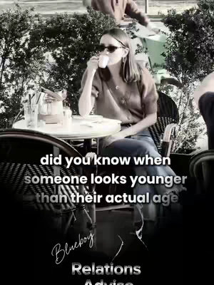 A black and white cover image showing a woman seated at a cafe table, sipping from a white cup. She is wearing sunglasses. Text overlays appear along the bottom.
