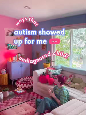 The cover image shows a vibrant, colorful interior scene. The room is painted in shades of pink and blue. A person who appears to be female is sitting on a light-colored sofa with a red-haired person. The text overlay says, 'ways that autism showed up for me'.
