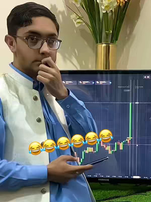 A young man wearing glasses and traditional attire stands in front of a monitor displaying a stock chart, holding a phone and touching his chin thoughtfully. Six laughing emojis overlay his arm and the chart in a diagonal row.
