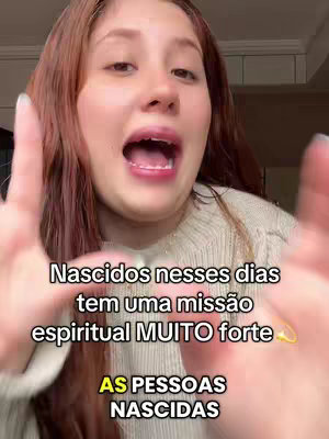 A woman with long red hair and fair skin is smiling and looking directly at the camera with her mouth open, hands extended out towards the viewer. Text overlays in the foreground. The background is blurred but appears to be an indoor domestic setting.